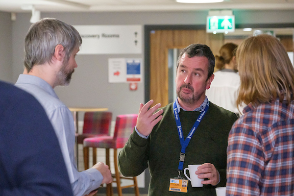 Networking at CAM2 2021 - Prof. Iain Todd talking to delegates at CAM2 2021