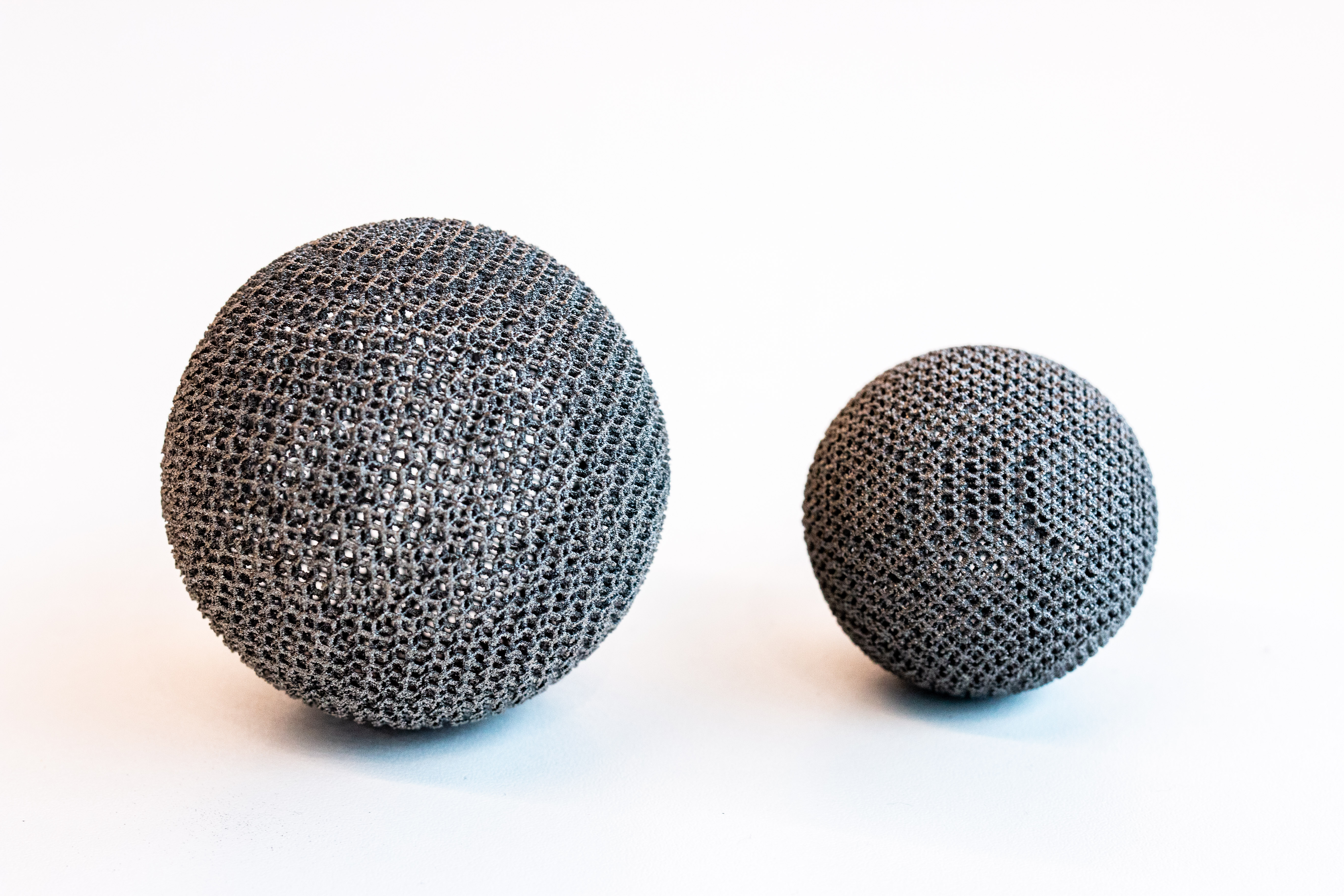 Two artefacts produced using the Arcam Q10plus. - Two artefacts, both hollow balls, produced using the Arcam Q10plus.