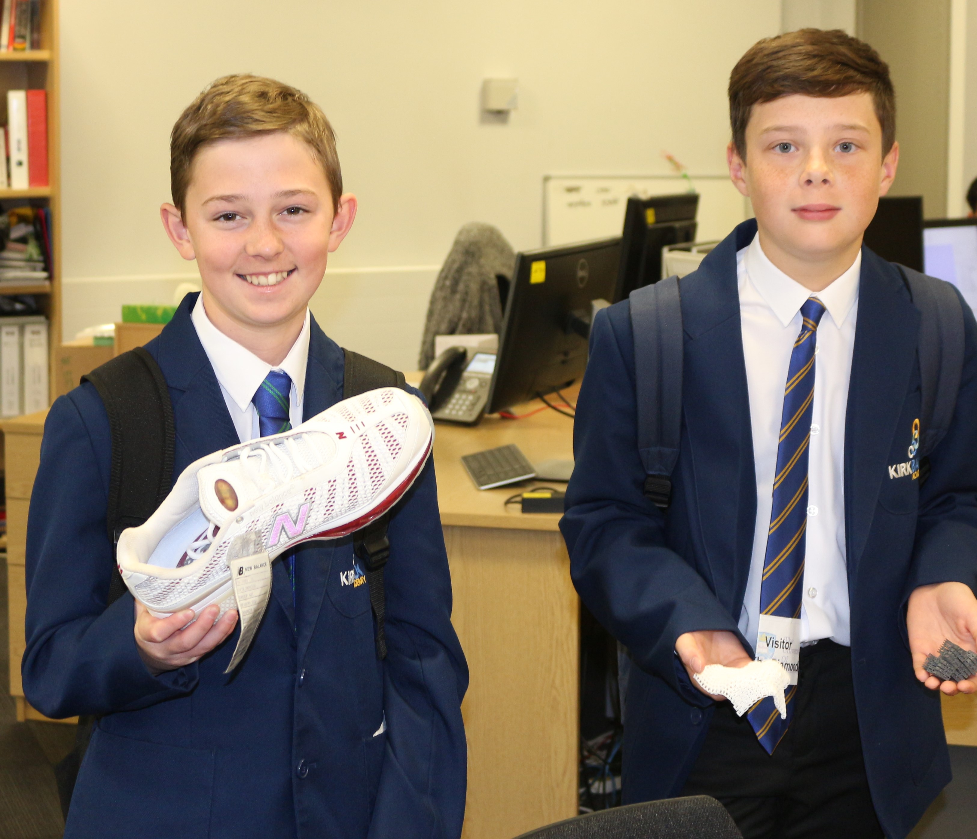 Two Kirk Balk pupils holding items made via additive manufacturing - Two Kirk Balk pupils holding items made via additive manufacturing during a visit to The University of Sheffield